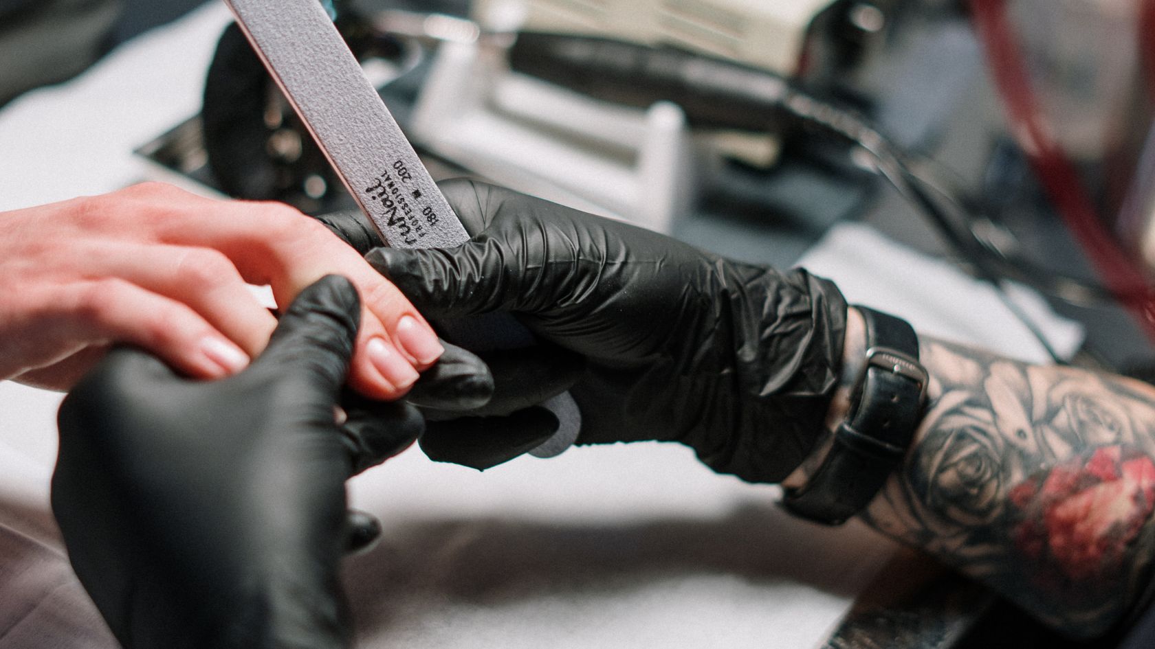 close up of nail technician filing nails